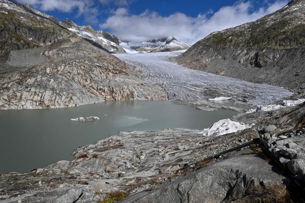 This photograph shows the Rhone Glacier and its glacial lake, formed by the melting of the glacier, above Gletsch, in the Swiss Alps on September 30, 2024. — AFP pic