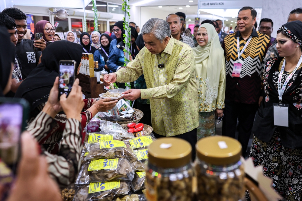 Deputy Prime Minister Datuk Seri Dr Ahmad Zahid Hamidi visits the exhibition booths at 'The Muslim World Women's Summit: Voices of HER Festival and Ibu Zain Awards' at the World Trade Centre yesterday. — Bernama pic