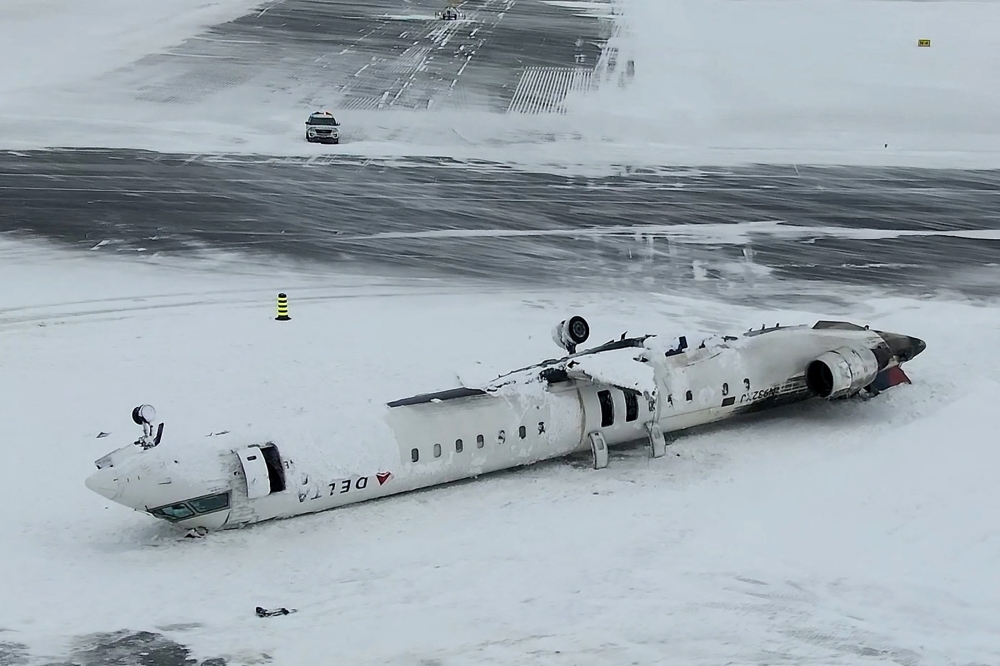 A drone view of the wreckage of a Delta Air Lines operated CRJ-900 aircraft lies crashed on the runway at Toronto Pearson International Airport in Mississauga, Ontario, Canada February 18, 2025 in a still image from video. — Reuters pic