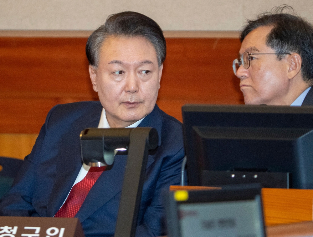 Yoon Suk Yeol (left) at the tenth hearing of his impeachment trial over his short-lived imposition of martial law at the Constitutional Court in Seoul. – Pic by AFP