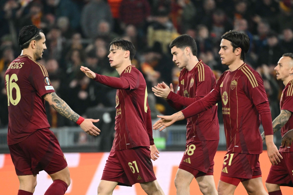 Roma’s Niccolo Pisilli celebrates with teammates scoring his team’s third goal. — Pic by AFP