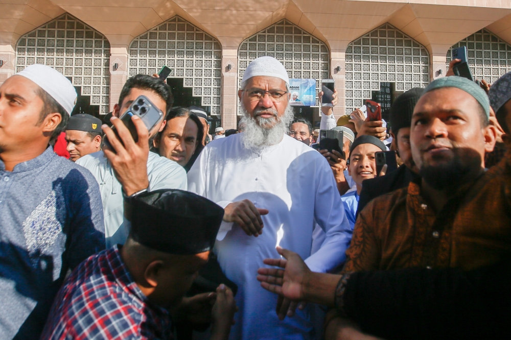 Muslim evangelist Dr Zakir Naik (centre) leaves the Putra Mosque in Putrajaya after perform the Aidiladha prayer. June 29, 2023. — Picture by Hari Anggara
