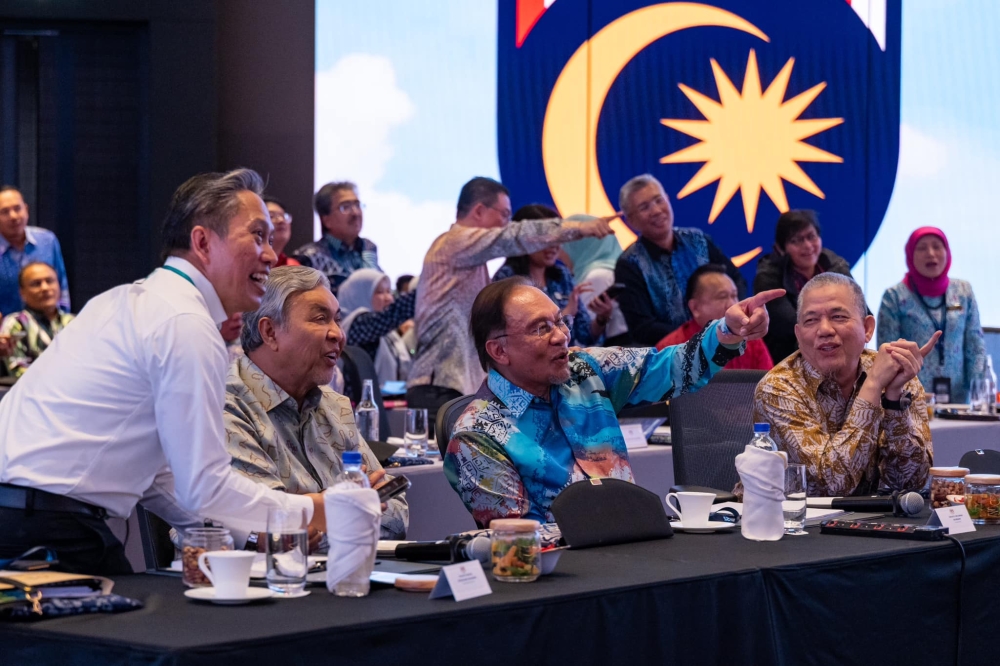 Prime Minister Datuk Seri Anwar Ibrahim and Cabinet members share a light-hearted moment during the two-day Madani Government Retreat 2025 in Bangi February 21, 2025. — Picture via Facebook