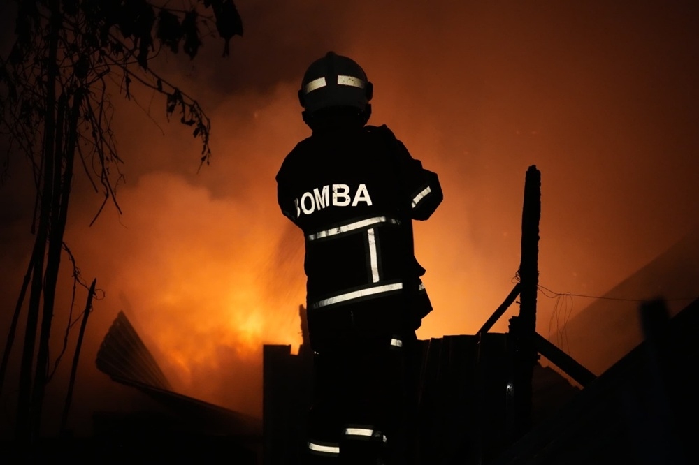 Bomba photo shows a firefighter working to extinguish the blaze. — Picture courtesy of the Fire and Rescue Department 