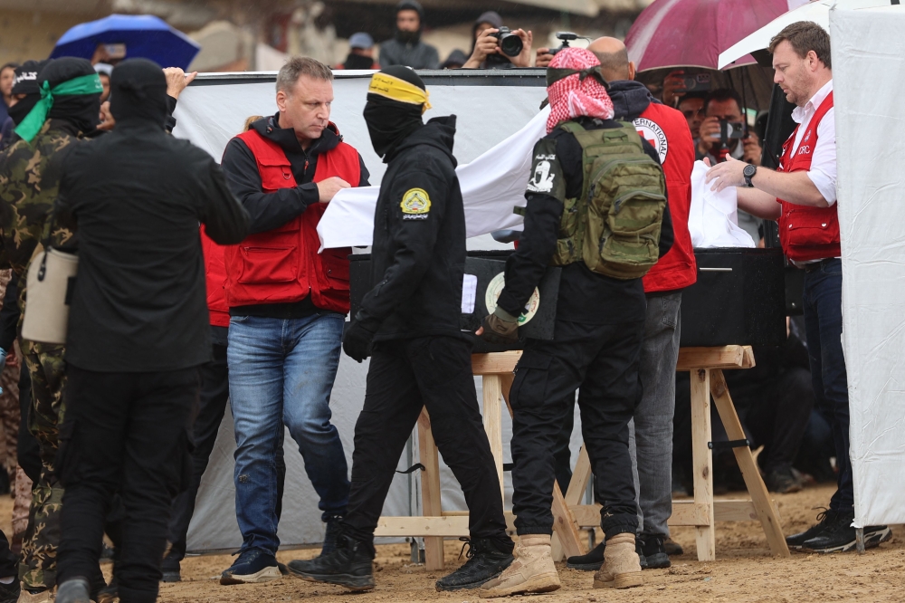 The Red Cross receiving one of four coffins during the handover  of the bodies of four Israeli hostages in Khan Yunis om Thursday.  —  Pic by AFP