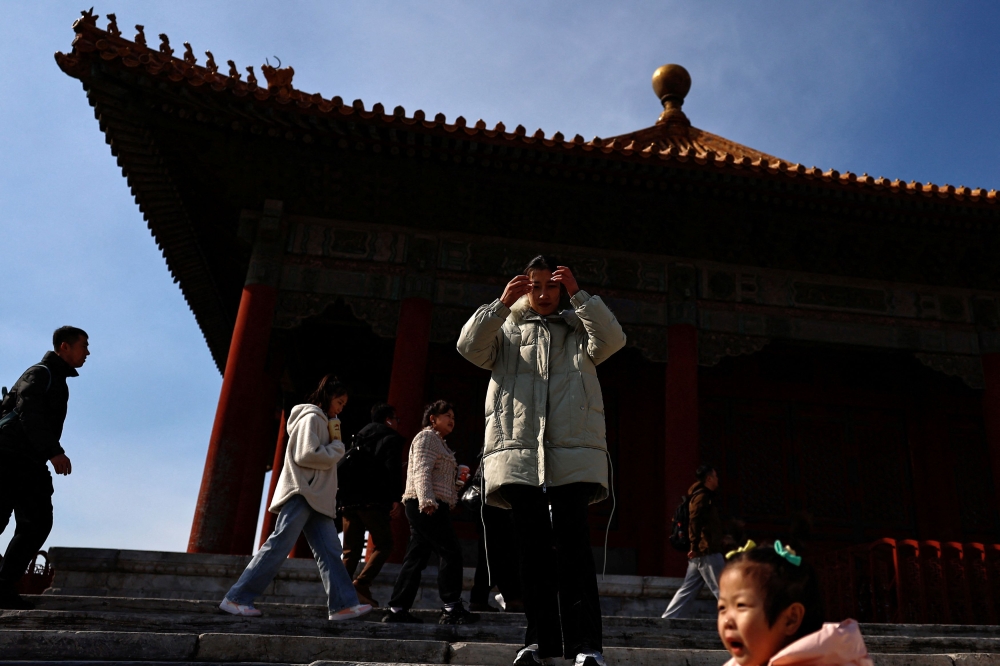 Tourists visit the Forbidden City in Beijing. — Reuters pic