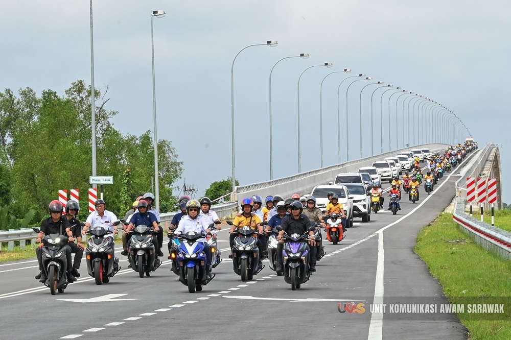 Sarawak Premier Abang Johari Openg (centre) drives down the Muara Lassa bridge on a motorcycle. — Picture courtesy of Ukas 