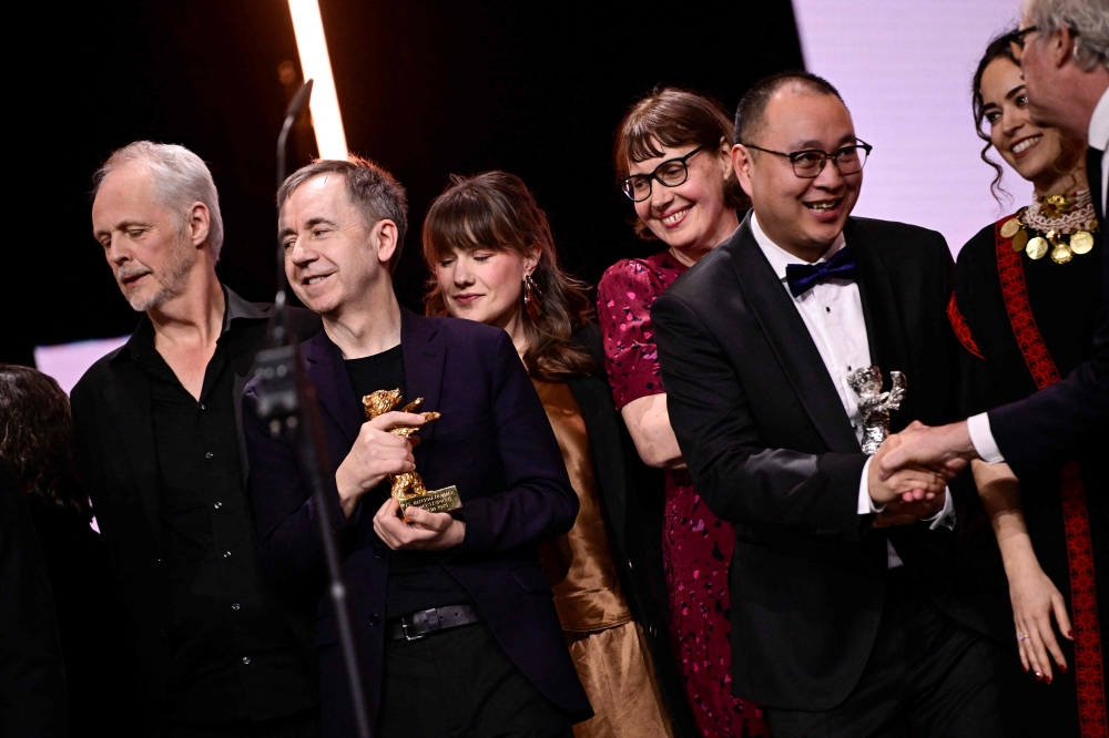 Norwegian director Dag Johan Haugerud (2L), Chinese film director Huo Meng (3R), French director and screenwriter Lucile Hadzihalilovic (4R) and other guests gather on stage before posing for a photo at the end of the award ceremony. — AFP pic