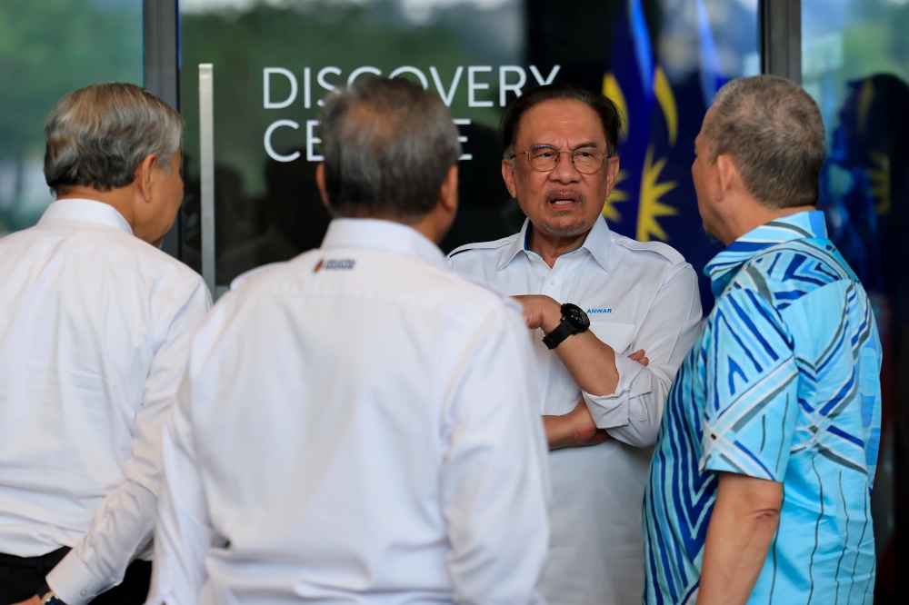 Prime Minister Datuk Seri Anwar Ibrahim speaks with fellow Cabinet members after the 2025 Madani Government Retreat media conference on February 22, 2025. — Bernama pic