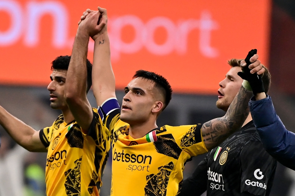 (Left to right) Inter Milan’s Mehdi Taremi, Lautaro Martinez and goalkeeperosep Martinez cheer fans after winning. — Pic by AFP