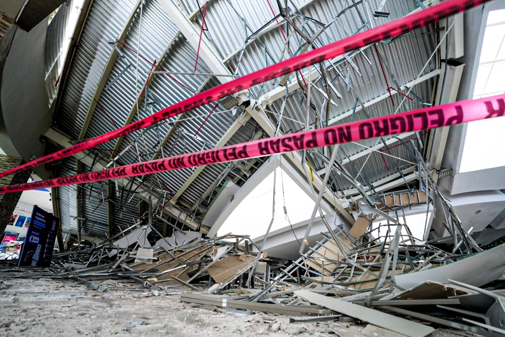 Handout picture released by Regional Government of La Libertad shows damages after the roof of a shopping mall collapsed in Trujillo, Peru. — Pic by AFP