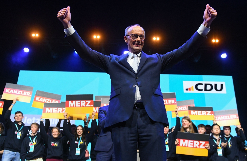 Friedrich Merz, Leader of conservative Christian Democratic Union (CDU) and main candidate gives the thumbs up sign at the end of the last electoral rally in the Rudolf Weber-Arena in Oberhausen. — Pic by AFP