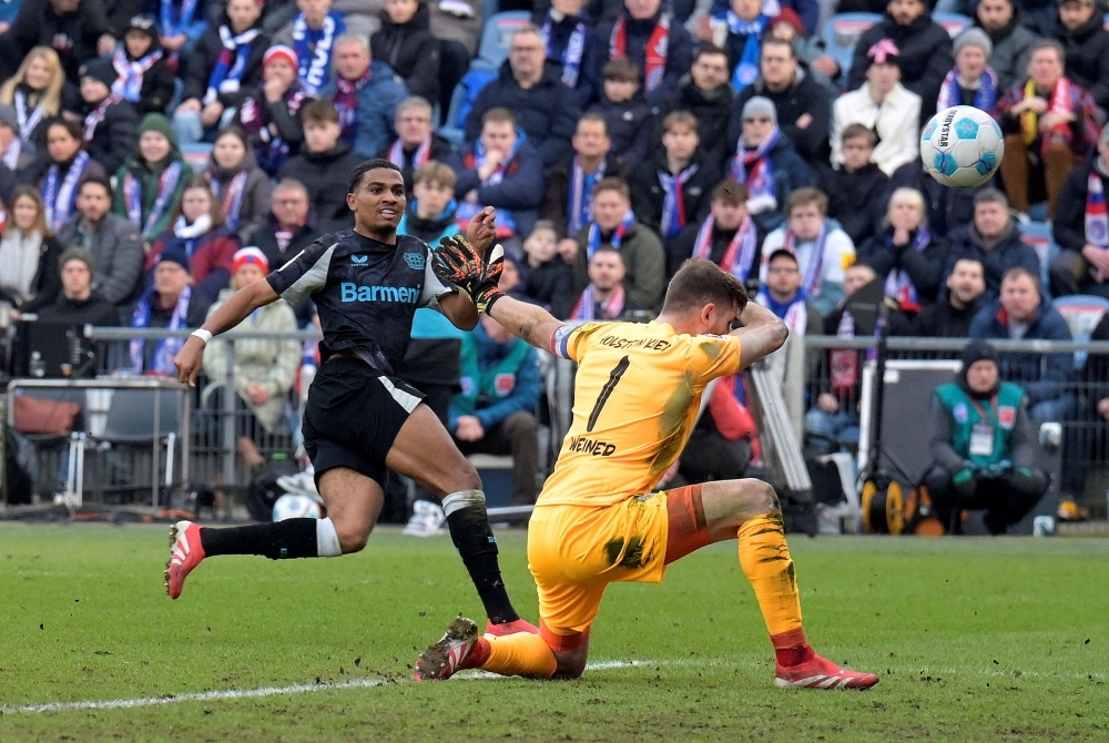 Bayer Leverkusen’s Amine Adli scores their second goal past Holstein Kiel’s Timon Weiner. — Pic by Reuters