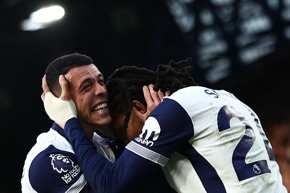 Tottenham Hotspur’s Djed Spence (right) celebrates scoring the team’s third goal. — Pic by AFP