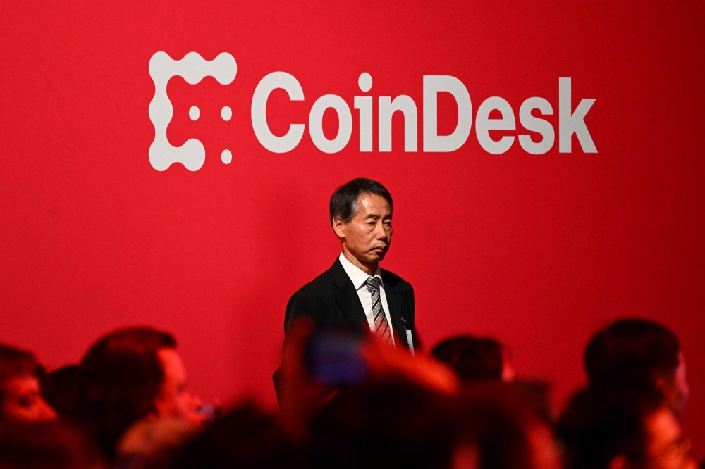 People listen to a keynote address at Consensus, the flagship event of Coindesk the data platform for the global crypto economy, at the Convention and Exhibition Centre in Hong Kong n February 19, 2025. — AFP pic