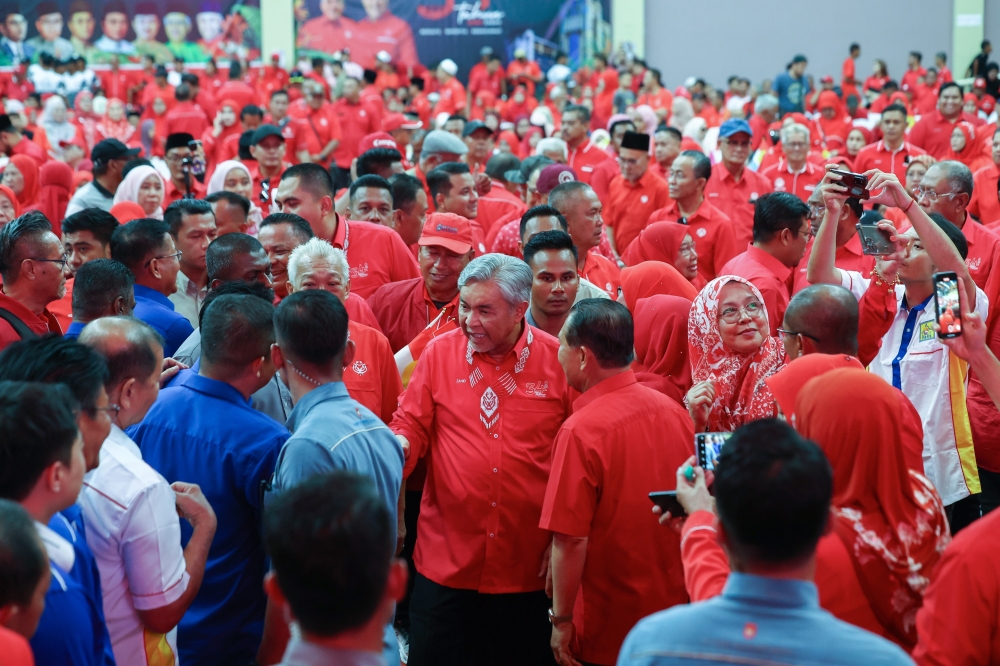 Deputy Prime Minister and Umno president Datuk Seri Ahmad Zahid Hamidi (centre) greets Umno members upon arriving at the 34th Sabah UMNO anniversary celebration at the Tawau Sports Complex yesterday. — Bernama pic