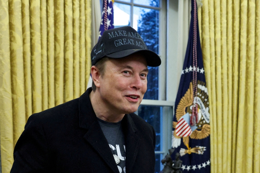 Elon Musk speaks next to US President Donald Trump (not pictured) in the Oval Office of the White House in Washington, D.C. February 11, 2025. — Reuters pic