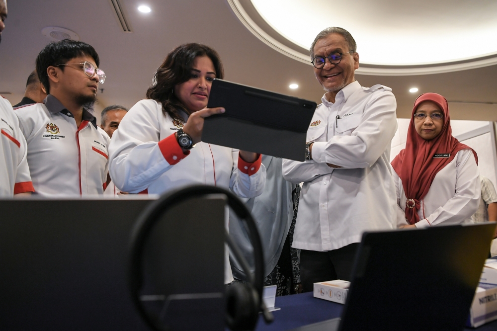 Health Minister Datuk Seri Dzulkefly Ahmad listens to a briefing during his visit to an exhibition booth after the launch of the First 1,000 Days of Life: Langkawi Longitudinal Study (LLS) (2025-2028) and the Cloud-Based Clinical Management System (CCMS) yesterday.