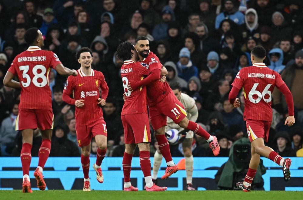 Liverpool’s Hungarian midfielder #08 Dominik Szoboszlai celebrates scoring the team’s second goal with Liverpool’s Egyptian striker #11 Mohamed Salah during the English Premier League football match between Manchester City and Liverpool at the Etihad Stadium in Manchester February 23, 2025. — AFP pic