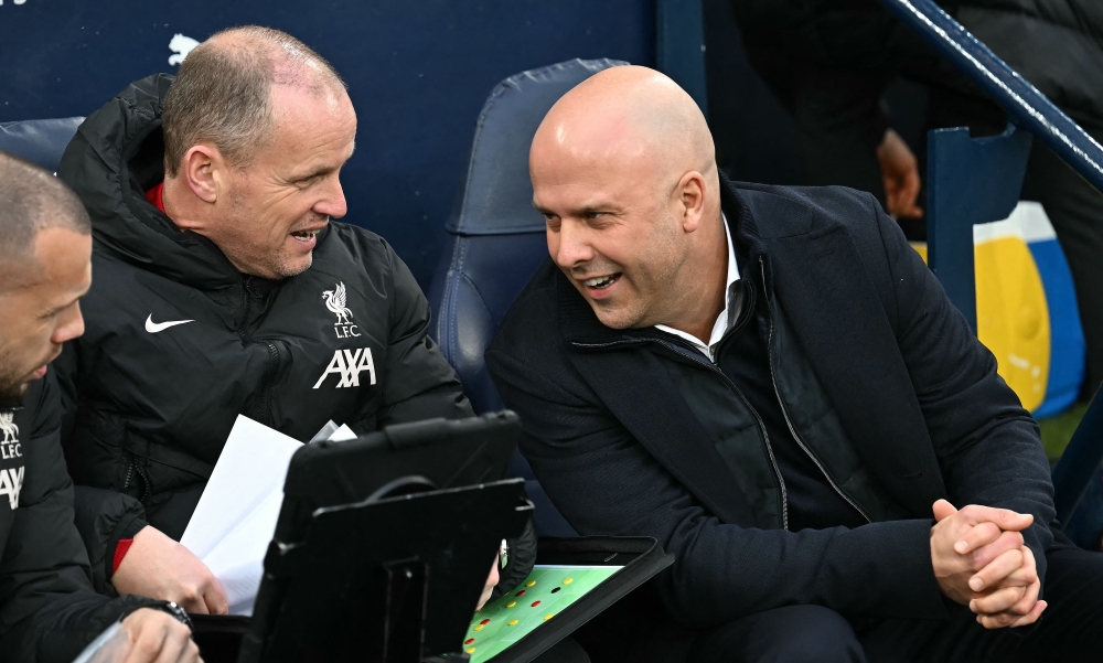 Liverpool's Dutch manager Arne Slot (right) talks with coaching staff ahead of the English Premier League football match between Manchester City and Liverpool at the Etihad Stadium in Manchester February 23, 2025. — AFP pic