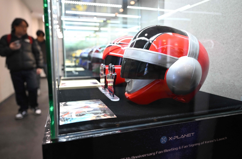 This picture taken on February 15, 2025 shows visitors looking at merchandise from Japanese superhero series ‘Choudenshi Bioman’ and ‘Hikari Sentai Maskman’ before a fan meeting at a concert hall in Seoul to mark the 35th anniversary of its release in South Korea. — AFP pic 