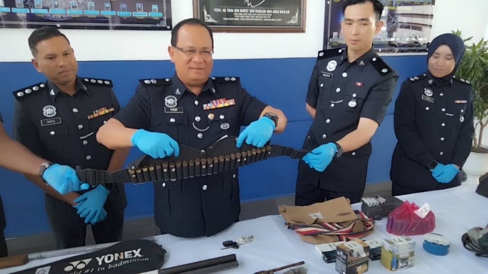 Kota Tinggi police chief Superintendent Yusof Othman (second fromleft) with the confiscated ammunition bandolier. — Picture courtesy of the Kota Tinggi district police