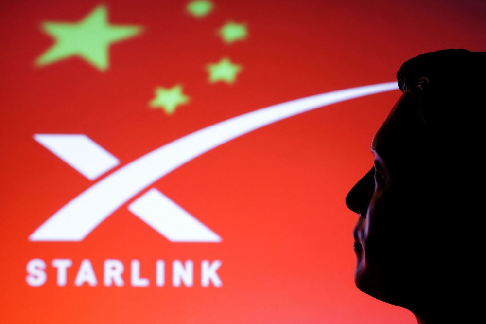 A 3D-printed miniature model of Elon Musk, a Chinese flag and the Starlink logo are seen in this illustration taken February 20, 2025. — Reuters pic 