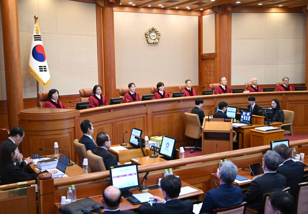 The Constitutional Court of Korea’s eight justices Chung Kye-sun, Kim Bok-hyeong, Jung Jung-mi, Lee Mi-son, Moon Hyung-bae, Kim Hyung-du, Cheong Hyung-sik and Cho Han-chang at the final hearing of South Korea’s impeached President Yoon Suk Yeol's short-lived imposition of martial law. – AFP