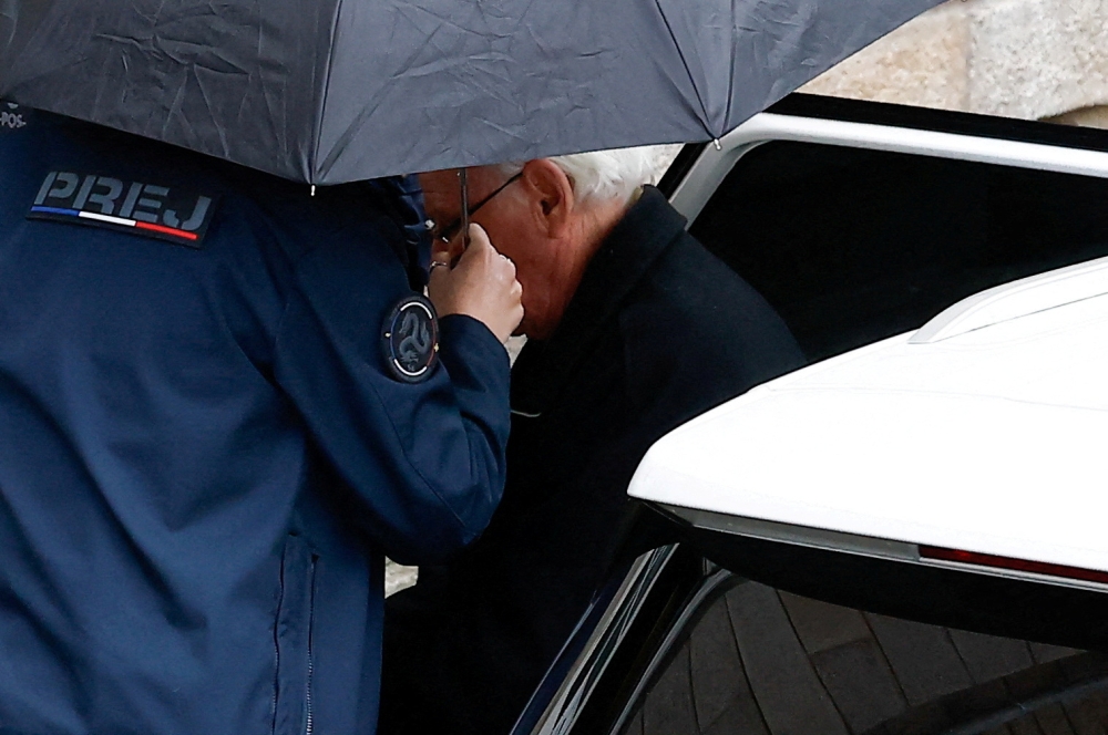 Prison officers escort ex-surgeon Joel Le Scouarnec from a vehicle, during his trial, where he is charged with aggravated rape and sexual assault against hundreds of children over several decades, in Vannes, Brittany, France, February 25, 2025. — Reuters pic 