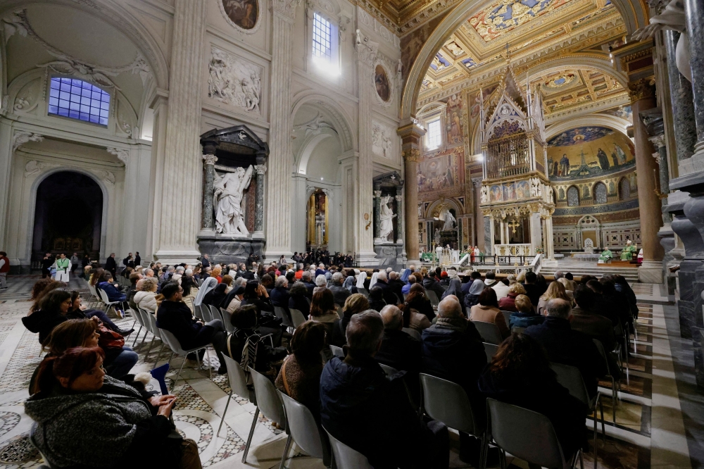 People attend a mass to pray for Pope Francis, who is in critical condition battling double pneumonia, inside Archcathedral of Saint John in Lateran, February 23, 2025. — Reuters pic 