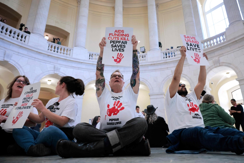 Demonstrators, some of them former PEPFAR and USAID employees, protest to demand that Congress stand up to President Donald Trump and Elon Musk’s Department of Government Efficiency and reinstate lifesaving programs in the Cannon House Office Building on Capitol Hill.  – AFP