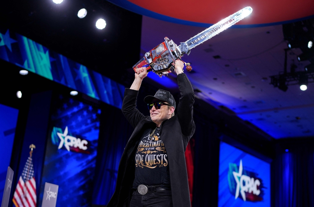 CEO of Tesla and SpaceX Elon Musk wields a chainsaw as he leaves the stage at the Conservative Political Action Conference (CPAC) at the Gaylord National Resort Hotel And Convention Center on February 20, 2025 in Oxon Hill, Maryland. — AFP pic