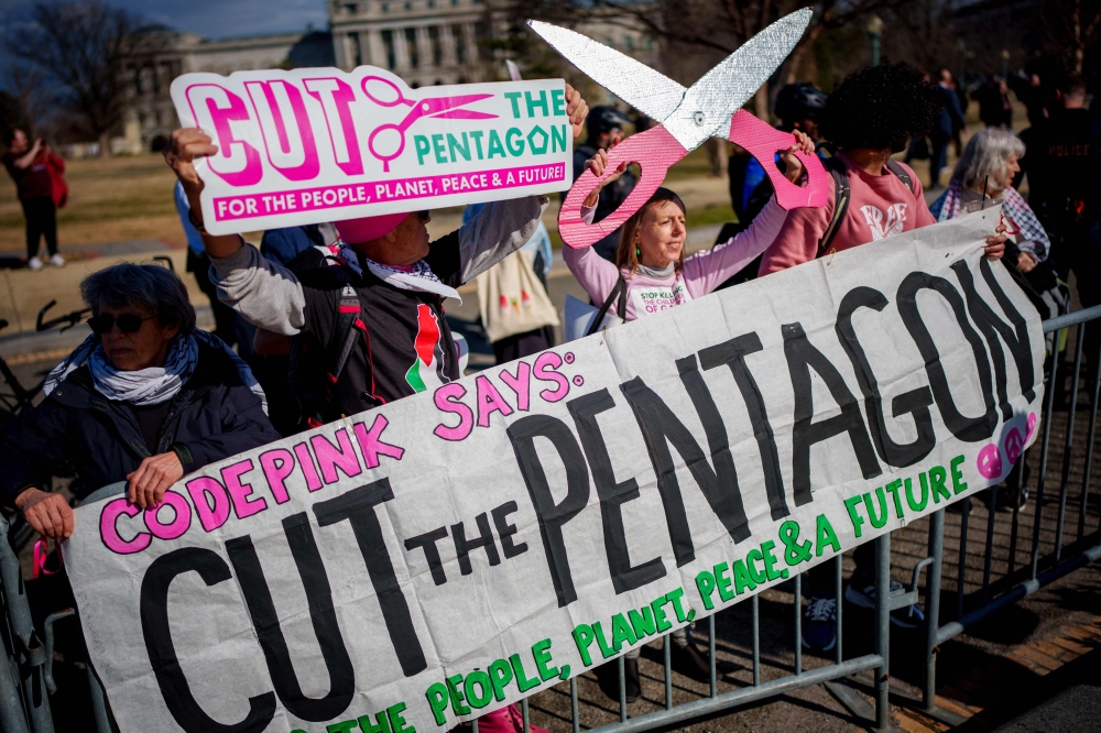 CodePink protesters hold up signs that read ‘Cut the Pentagon’ on Capitol Hill in Washington, DC. — AFP pic