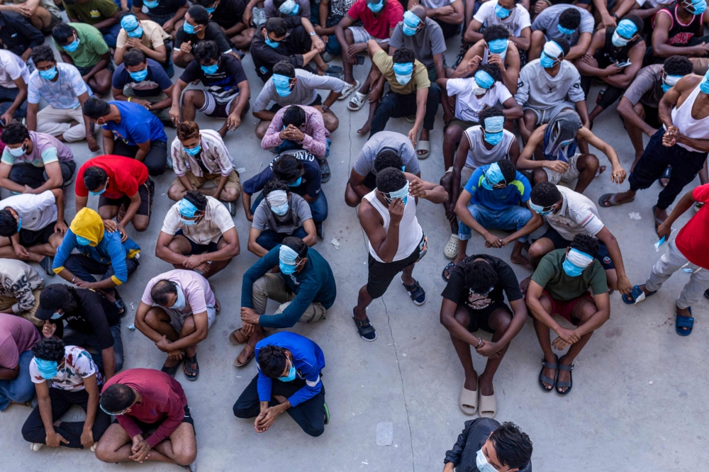 Alleged scam centre workers and victims are pictured during a crackdown operation by the Karen Border Guard Force (BGF) on illicit activity at the KK Park complex in Myanmar's eastern Myawaddy township on February 26, 2025. — AFP pic