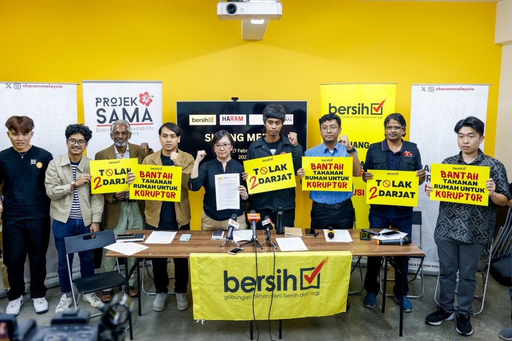 Bersih committee members pose with placards at group's headquarters in Petaling Jaya on February 27, 2025. — Picture by Firdaus Latif