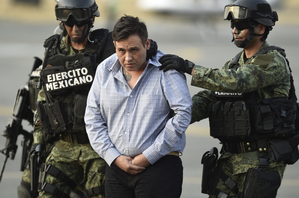 The alleged leader of the Zetas drug cartel, Oscar Omar Trevino, aka ‘Z-42’ is taken under custody to be presented to the press at the Attorney General Office’s hangar at the airport in Mexico City, on March 4, 2015. — File pic by AFP