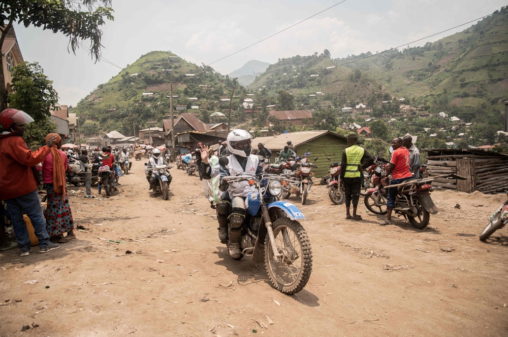 A Doctors Without Borders (MSF) staff member drives on a motorcycle coming from the high plateau, heading towards Minova yesterday. — Pic by AFP
