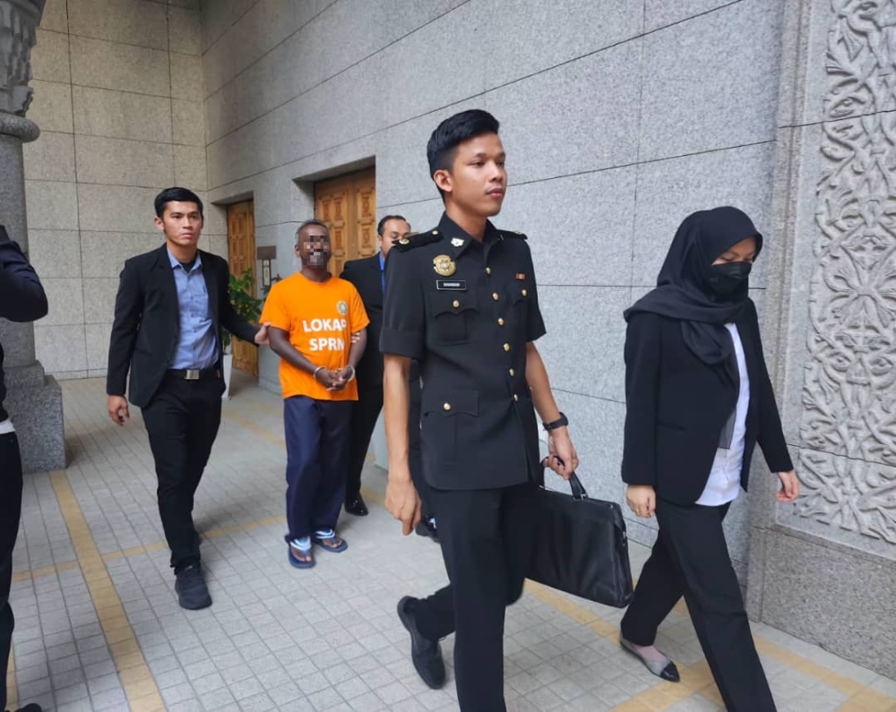 A reporter was brought to the Magistrate's Court in Putrajaya for remand over an alleged bribery case.March 1, 2025. — Picture courtesy of MACC