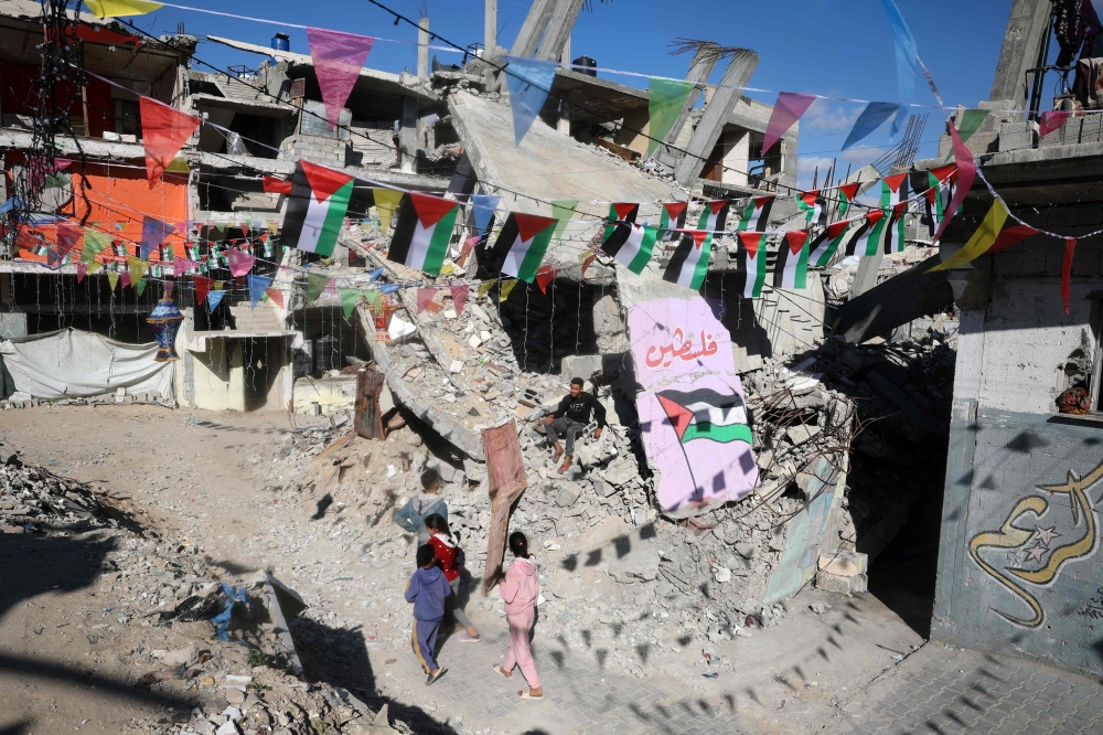Children walk in war-devastated neighbourhood, decorated ahead of the Muslim holy fasting month of Ramadan, in Khan Yunis in the southern Gaza Strip. – Pic by AFP