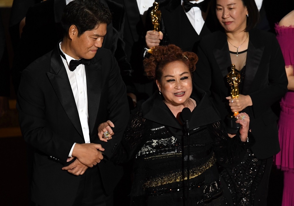 (From left) Executive producers Min Heoi Heo and Miky Lee accept the Best Picture award for ‘Parasite’ during the 92nd Annual Academy Awards at Dolby Theatre in Hollywood, California February 9, 2020. — AFP pic