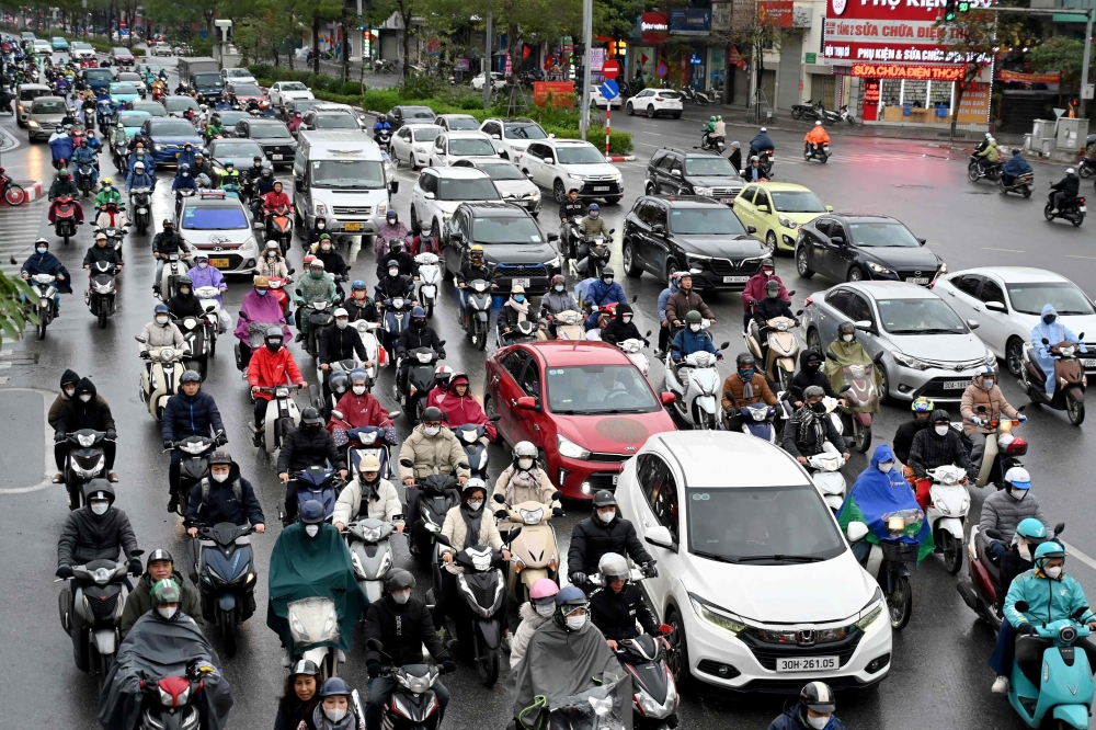 Life in Hanoi goes on as normal no matter how bad the air. — AFP pic
