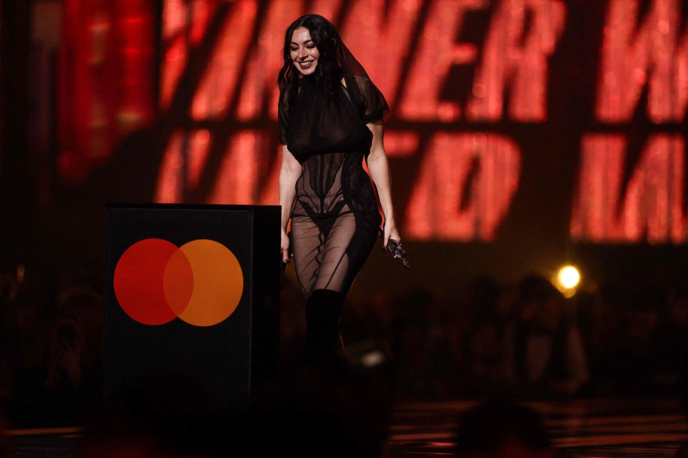 British singer Charli XCX celebrates on stage after receiving the award for Album of the Year at the BRIT Awards. – Pic by AFP