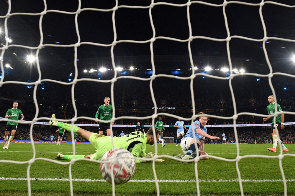 Manchester City’s Kevin De Bruyne scores the team’s third goal during the English FA Cup fifth round football match against Plymouth Argyle. – Pic by AFP