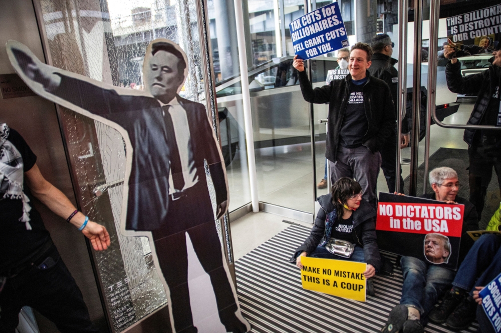 People protest inside a Tesla store during a National Day of Tesla Protest in New York City. – Pic by Reuters