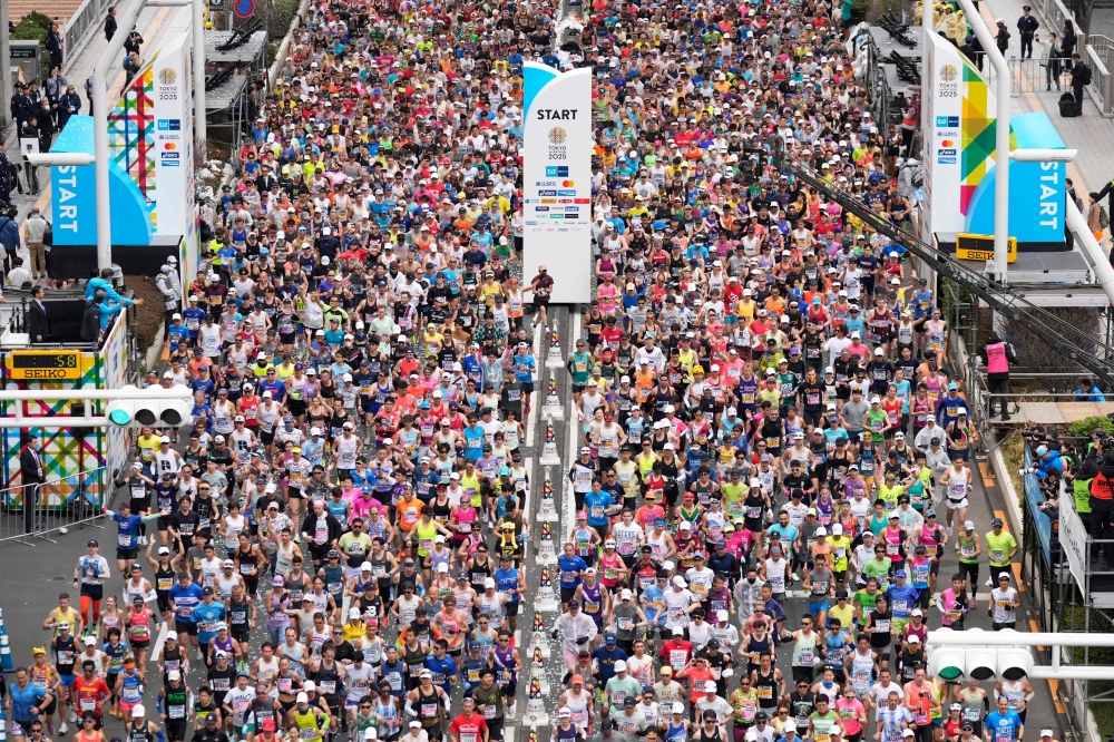 Participants at the Tokyo Marathon today. — AFP pic