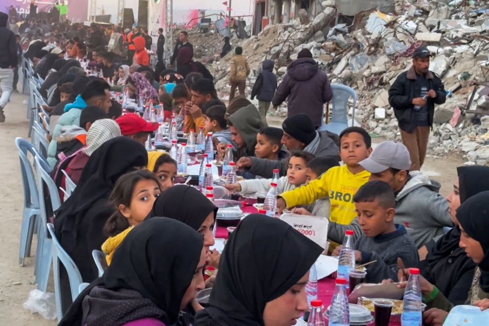 Palestinians gather for a communal iftar, or fast-breaking meal, on the first day of the Muslim holy month of Ramadan. — AFP pic