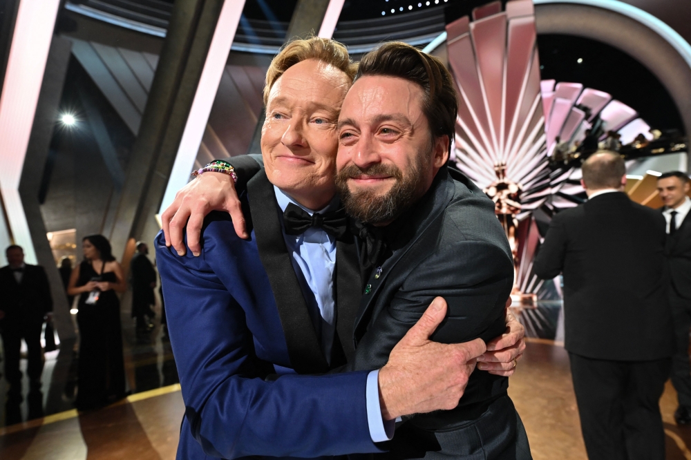 Kieran Culkin embraces Conan O'Brien at the end of the 97th Annual Academy Awards at the Dolby Theatre in Hollywood, California on March 2, 2025. — AFP pic