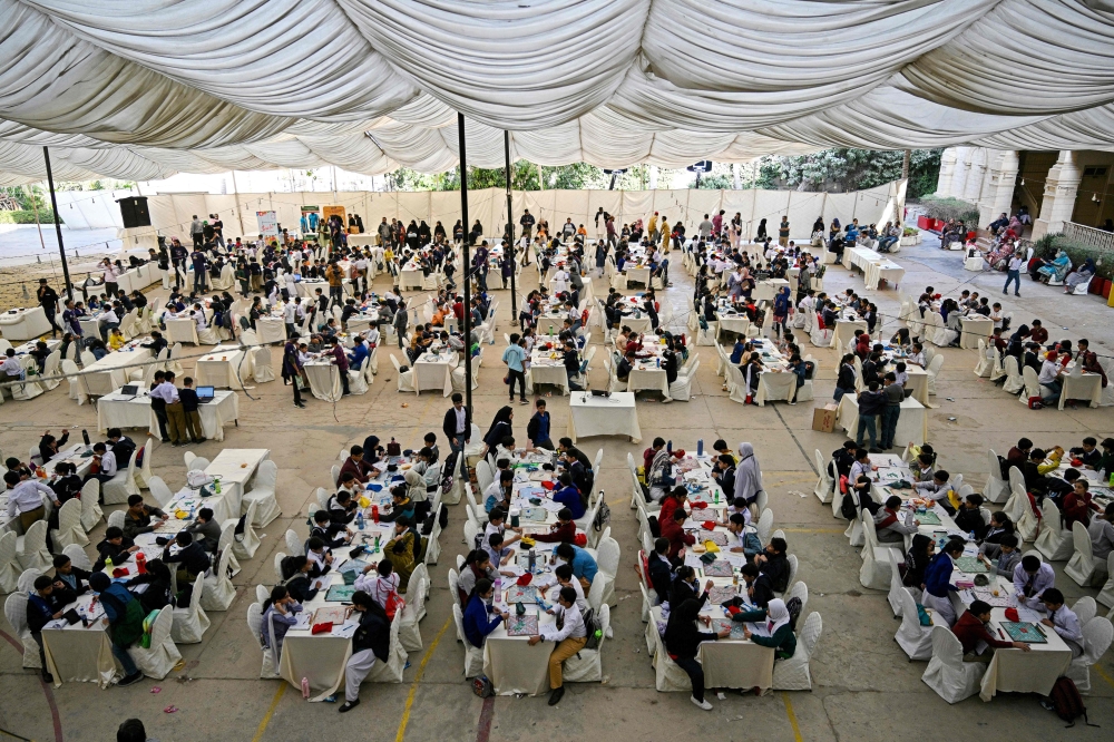Students compete in an inter-school Scrabble championship organised by the Pakistan Scrabble Association (PSA) at Bai Virbaiji Soparivala (BVS) Parsi school in Karachi. — AFP pic