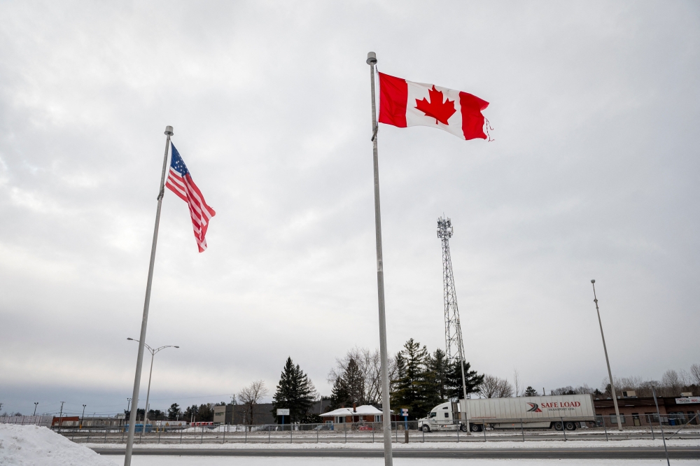 The Canadian and US flags fly near the Canada-US border in Blackpool, Quebec, Canada, on February 2, 2025. — File pic via AFP