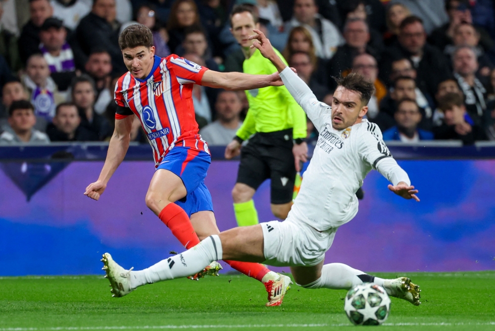 Atletico Madrid's Argentine forward #19 Julian Alvarez (L) shoots defended by Real Madrid's Spanish defender #35 Raul Asencio during the UEFA Champions League Round of 16 first leg football match between Real Madrid CF and Club Atletico de Madrid. — AFP pic 